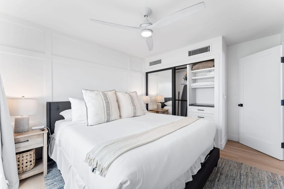 The first bedroom includes a king-size bed with fresh, clean bedding.