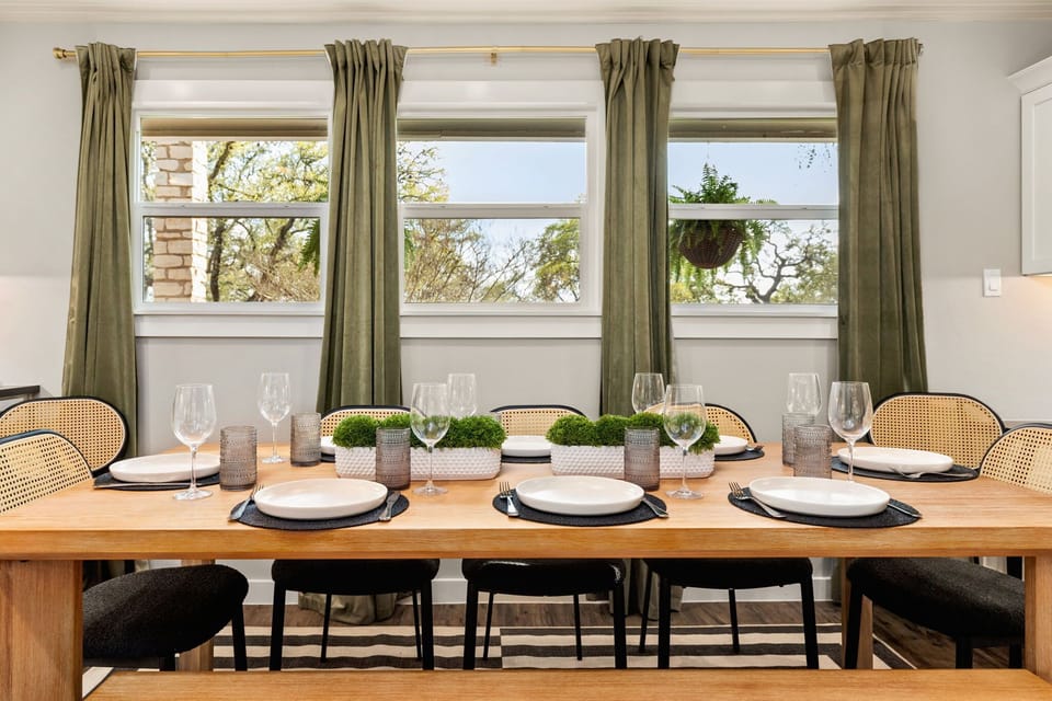 Spacious dining area with large table and bench seating.