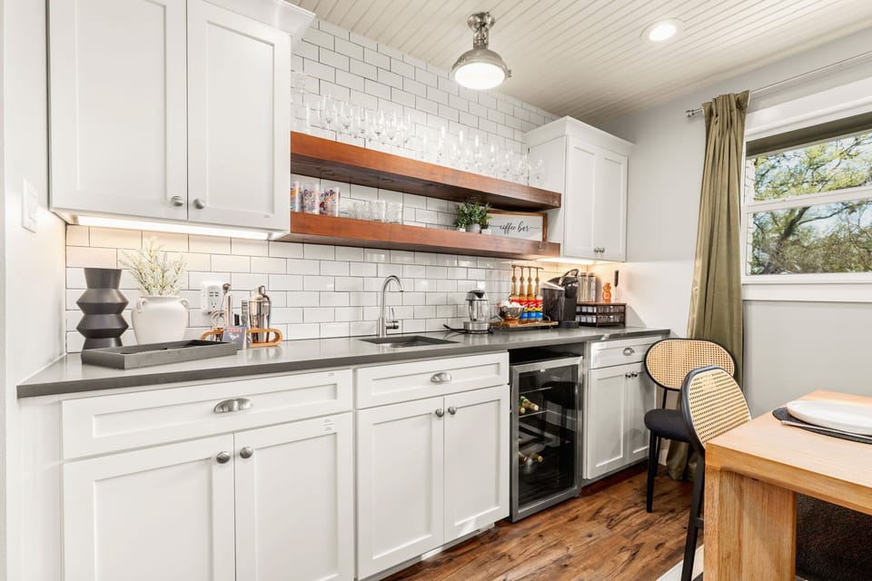 Dedicated wet bar with sink, wine fridge, and coffee bar.