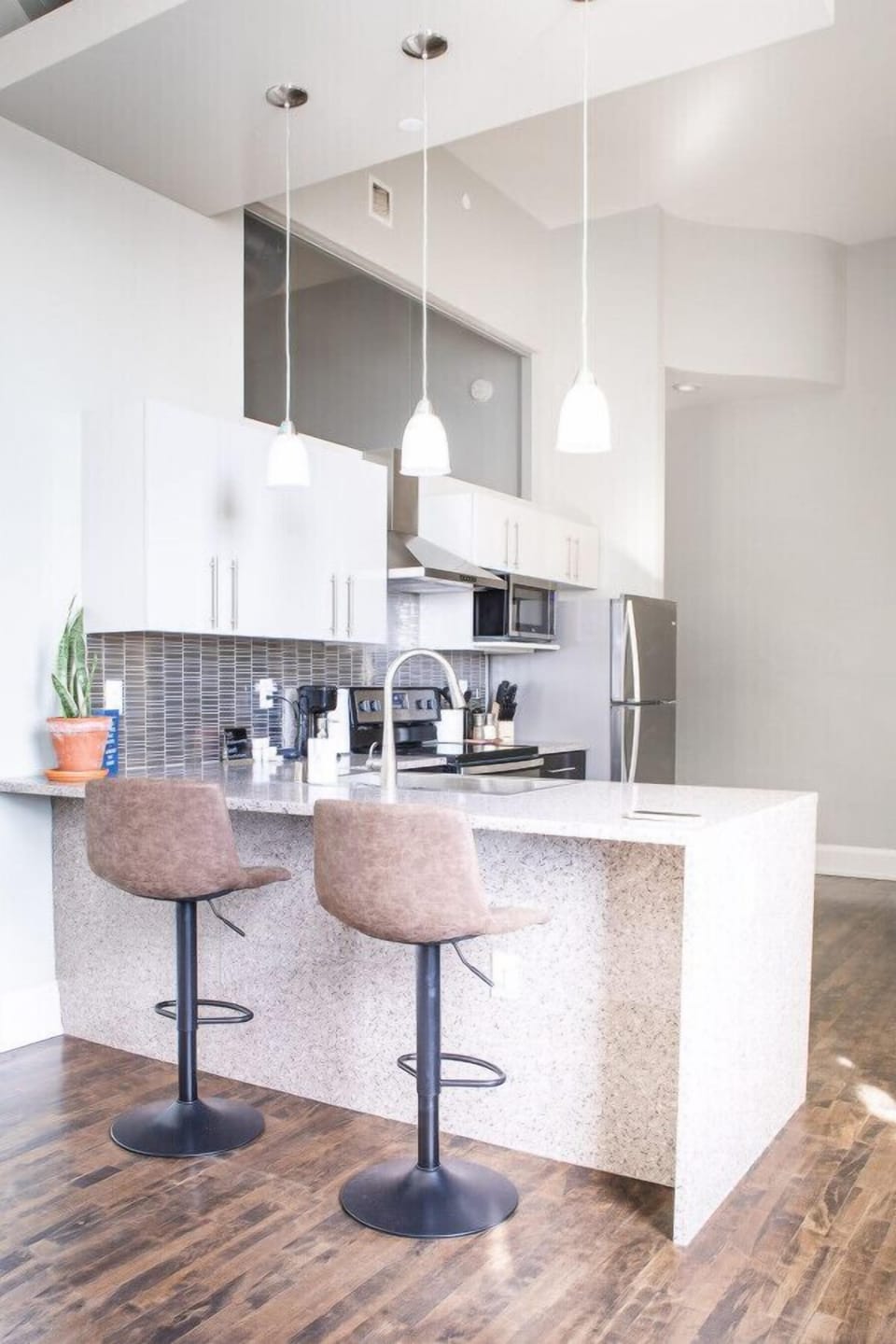 Full kitchen with bar stool seating and dining table