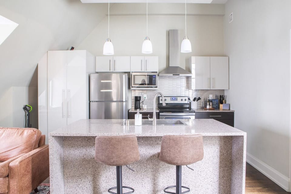 Kitchen with bar stool seating and in-unit laundry