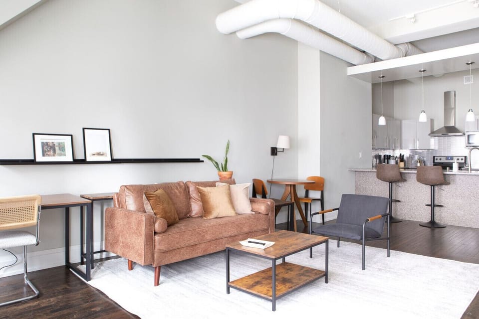 Spacious living area with abundant natural light, dedicated workspace, and dining/work table