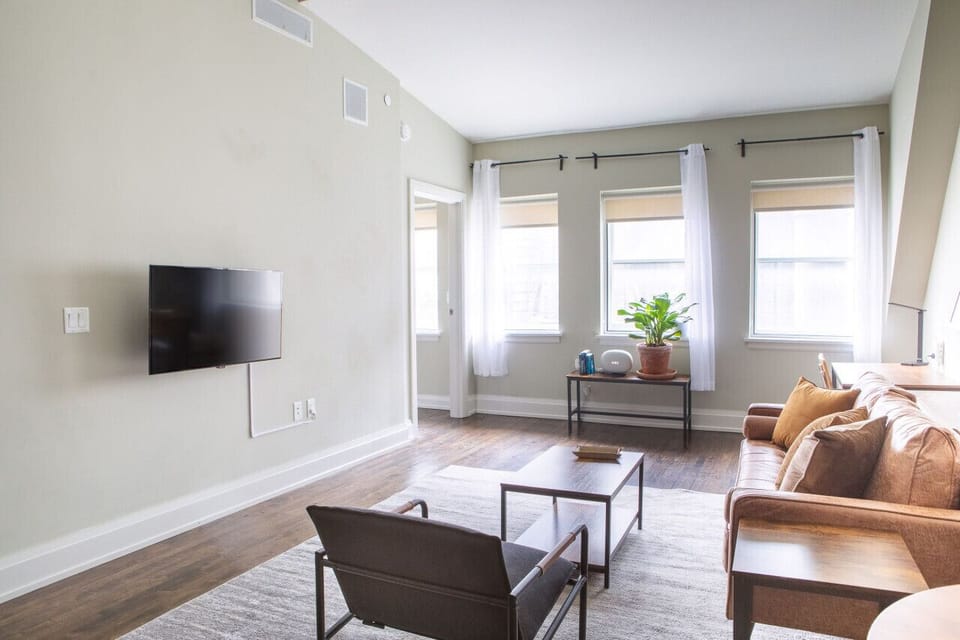 Spacious living area with abundant natural light, dedicated workspace, and dining/work table