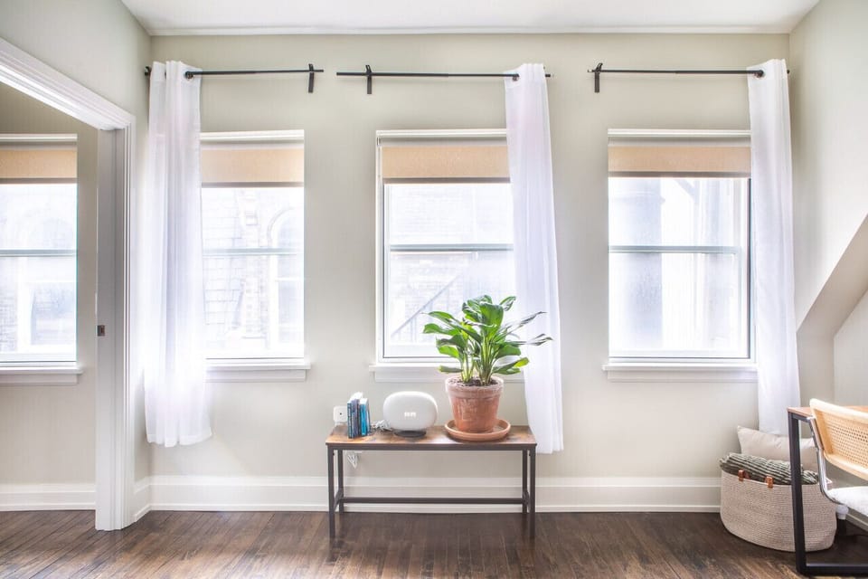 Spacious living area with abundant natural light, dedicated workspace, and dining/work table