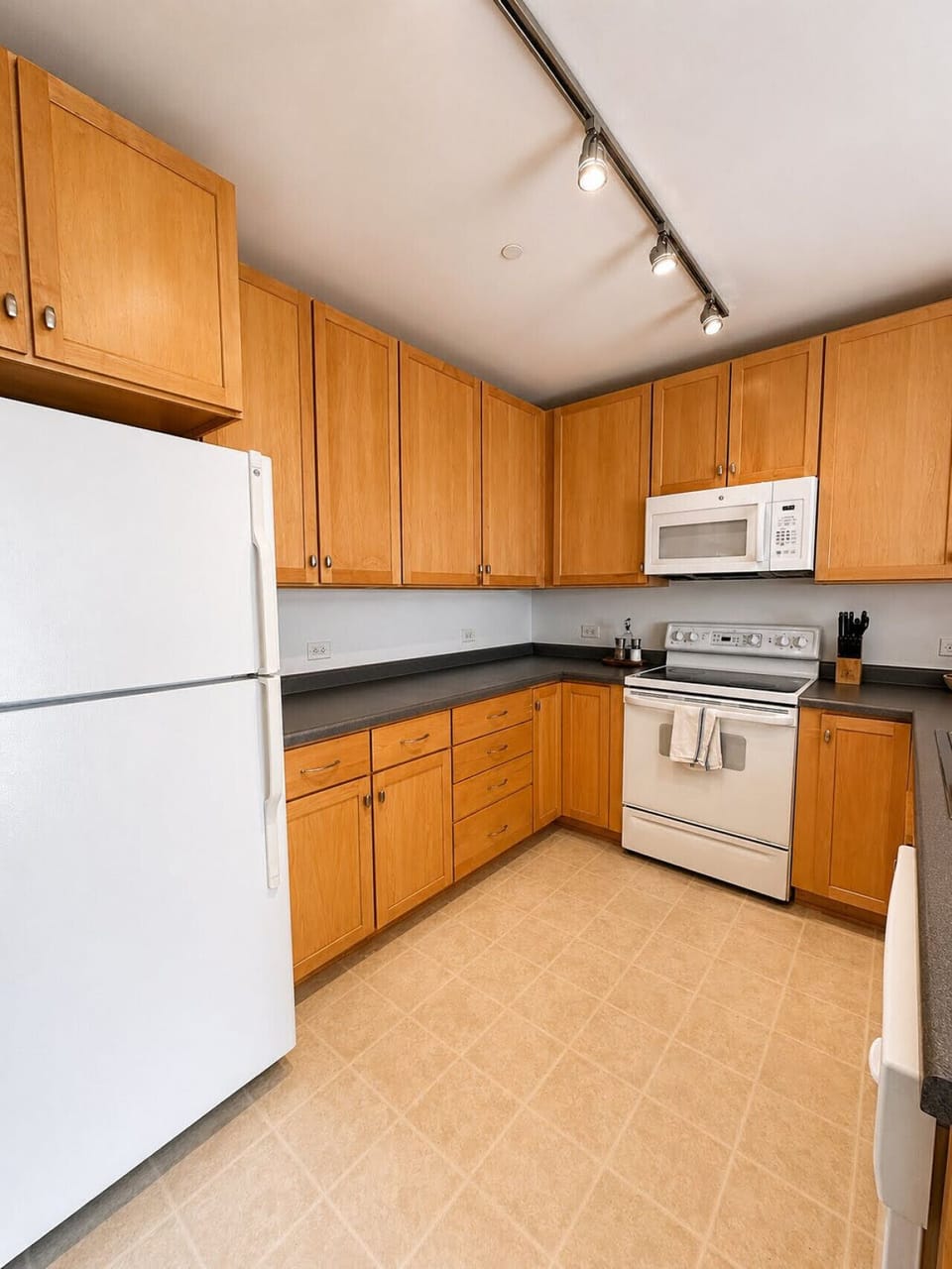 Fully-equipped kitchen featuring ample counter space and a raised breakfast bar for casual meals