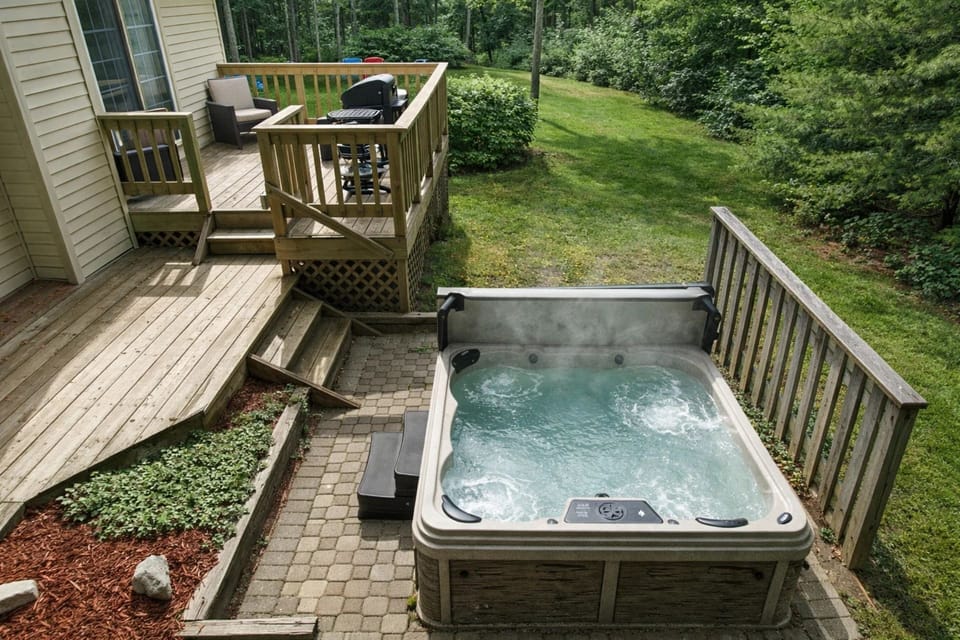 Outdoor Oasis: Unwind in the inviting hot tub surrounded by lush greenery—your relaxation haven awaits!