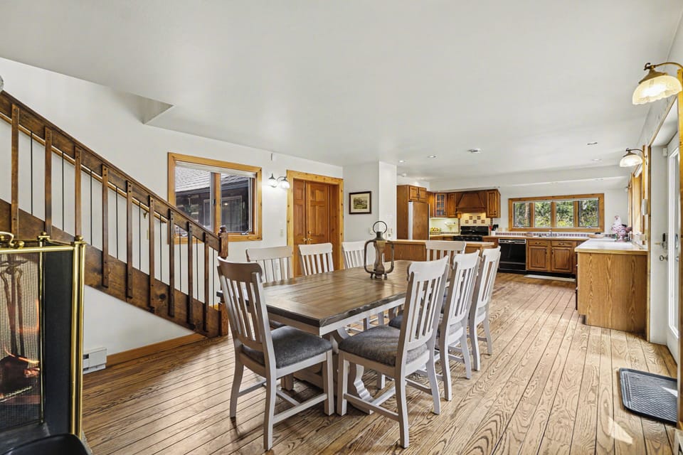 Gather around your spacious dining table where warm wood tones and natural light create the perfect setting for memorable meals together.