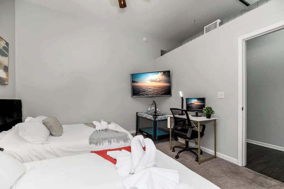 Bedroom with work area and TV