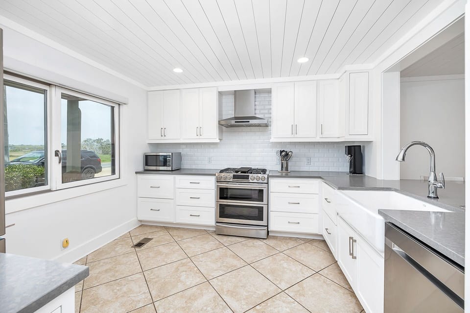 Chef's kitchen with gas range. Enjoy the marsh view while cooking. 