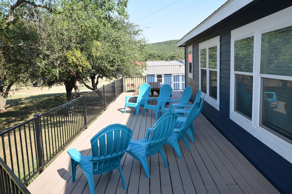 Large deck with dining table and lounge chairs