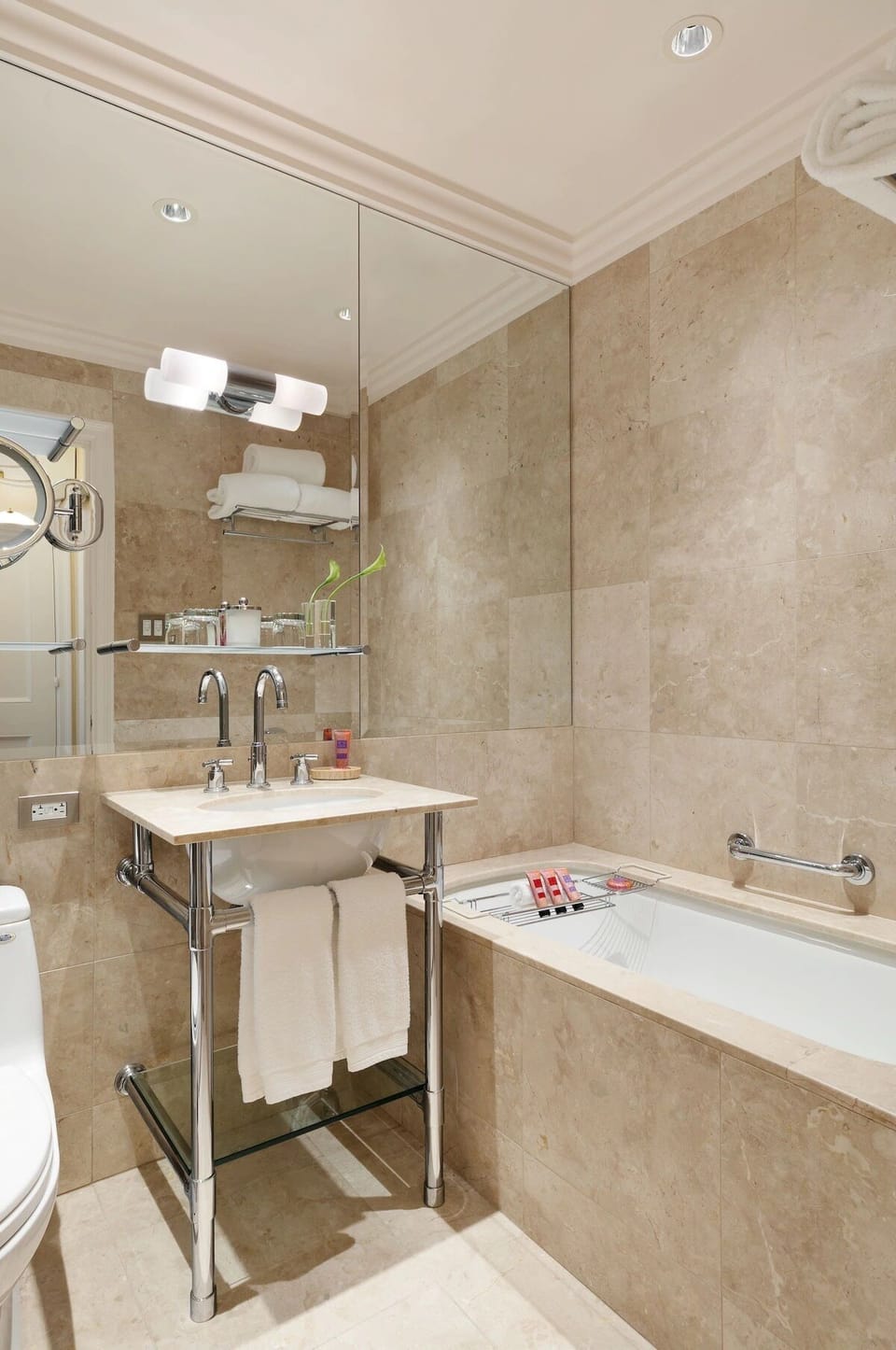 Refresh in a sleek marble bath with hotel-style amenities.