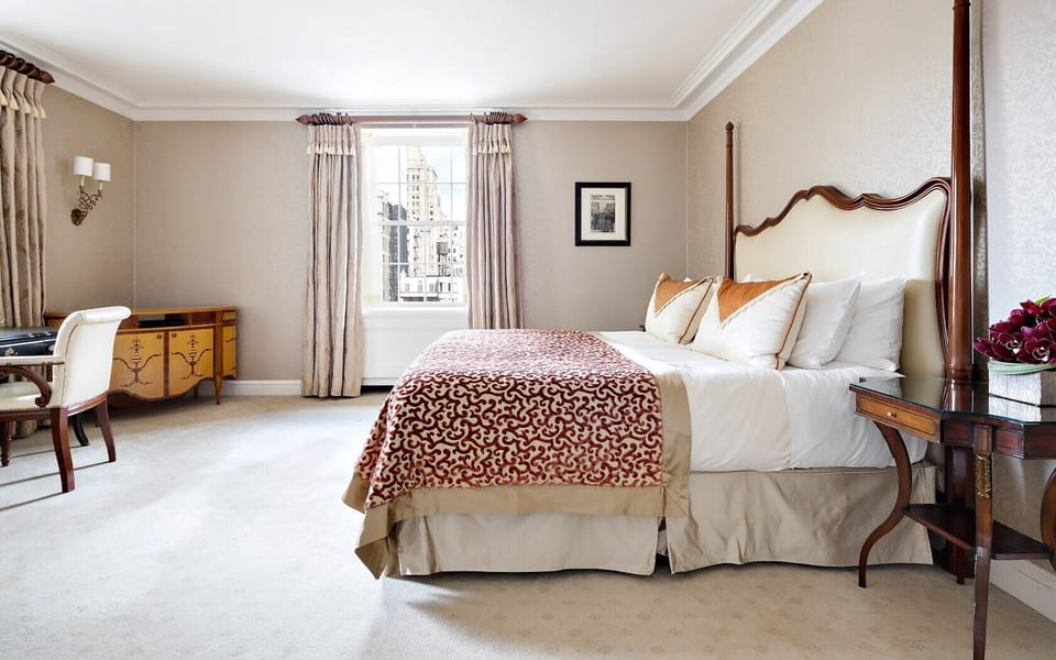 Recharge in a spacious bedroom with crisp linens and calm tones.