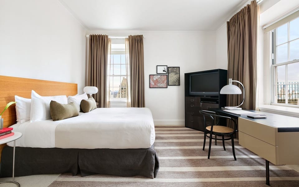 Settle into crisp linens beside a convenient work desk.
