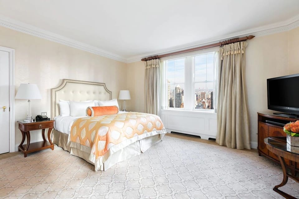 Unwind in a plush king bed with skyline views.