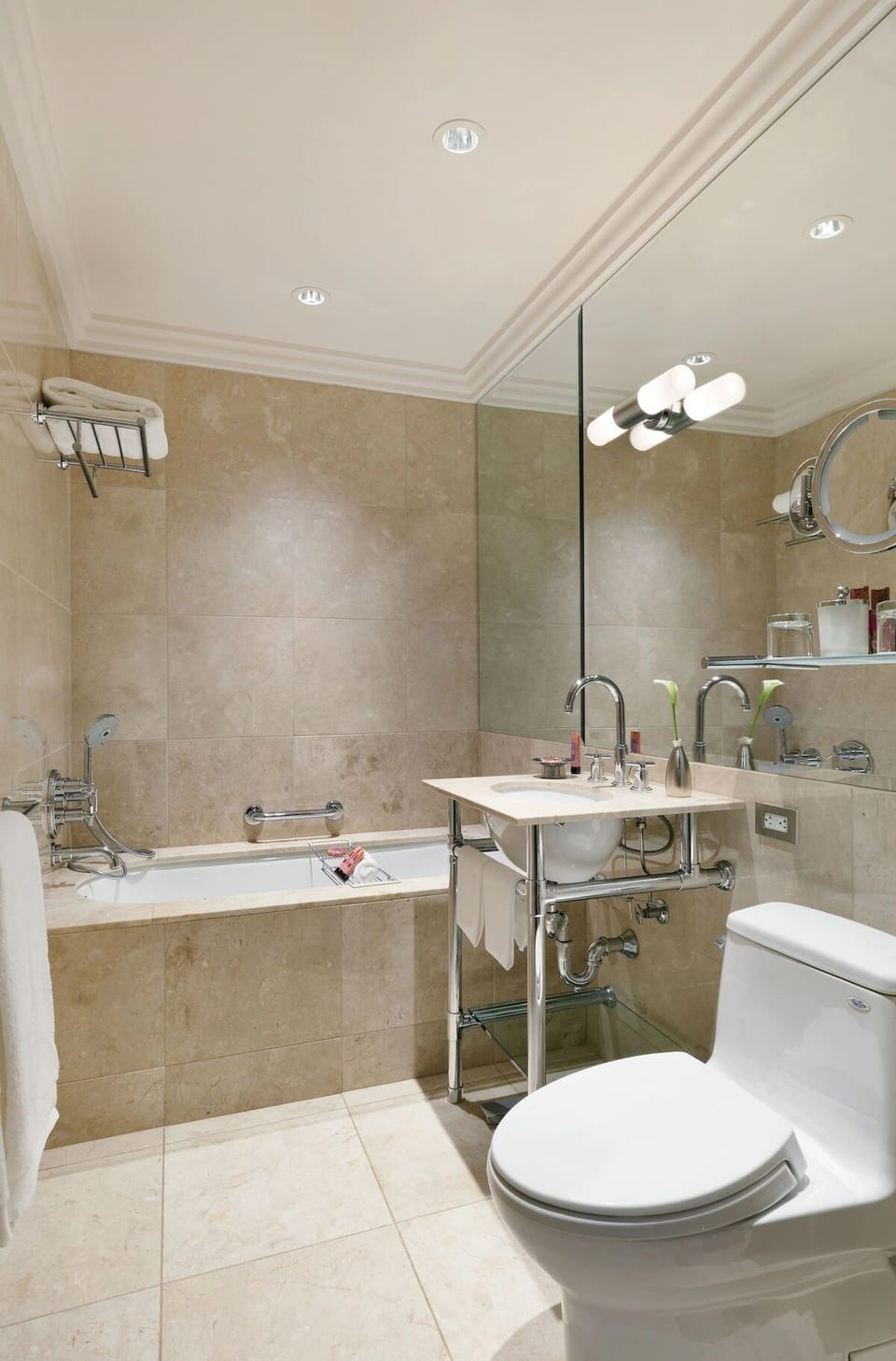 Refresh in a polished bath with bright vanity lighting.