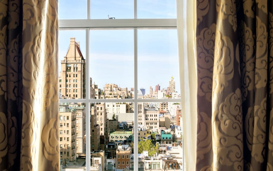 Wake up to sparkling skyline views through grand windows.