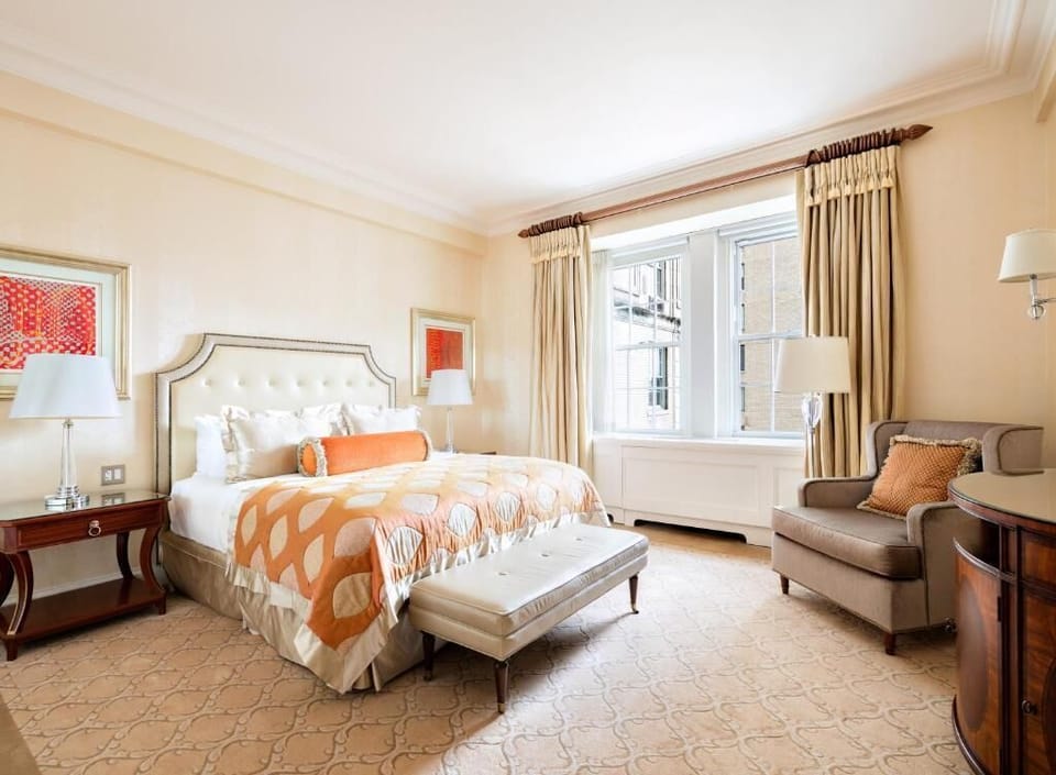 Unwind in a spacious bedroom with elegant, tailored linens