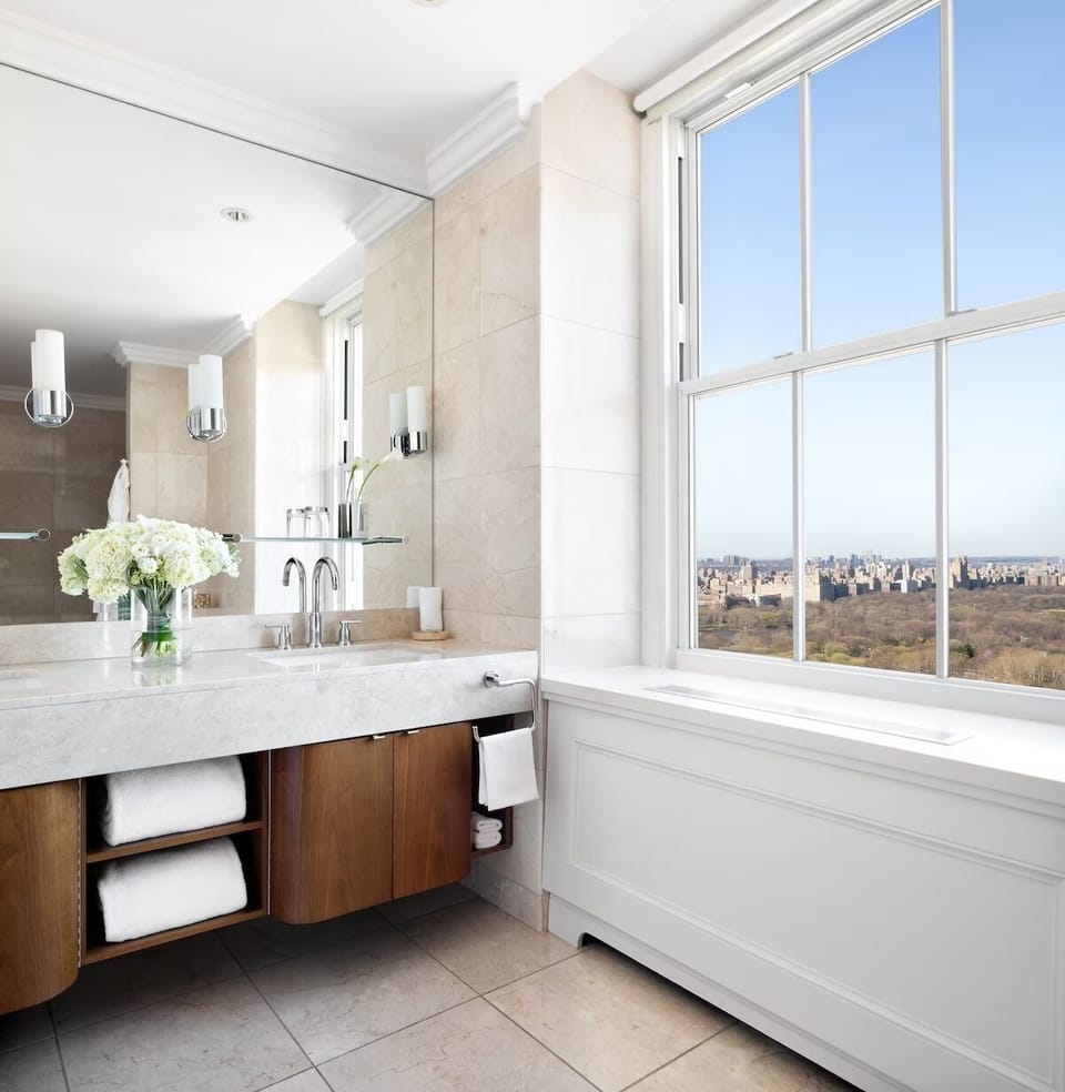 Refresh in a bright bath with skyline-view soaking ambiance