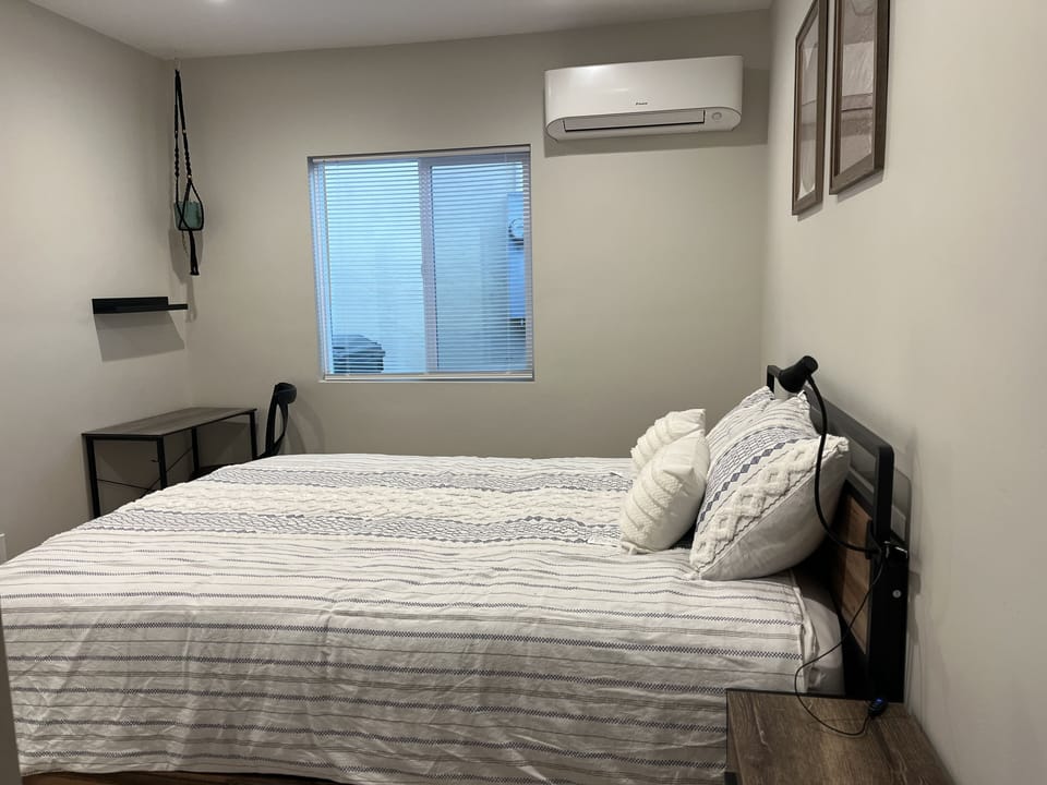 Queen bed; workspace; closet with hangers 