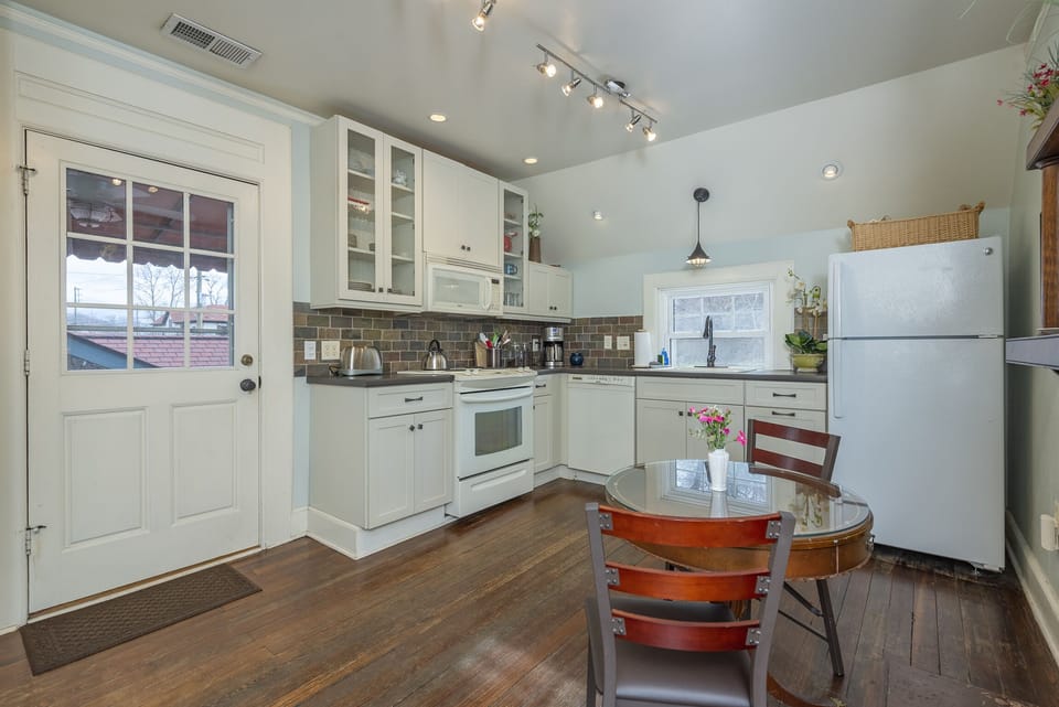 Kitchen with eat-in dining for 2, a dishwasher, and a standard drip-style coffeemaker.