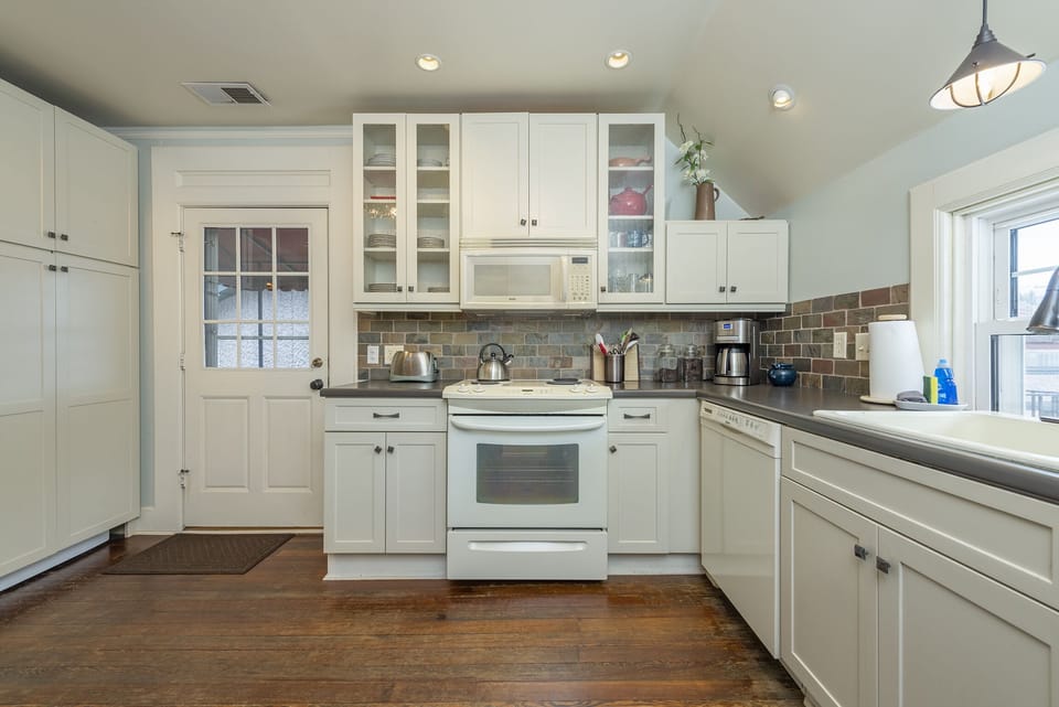 Kitchen with eat-in dining for 2, a dishwasher, and a standard drip-style coffeemaker.