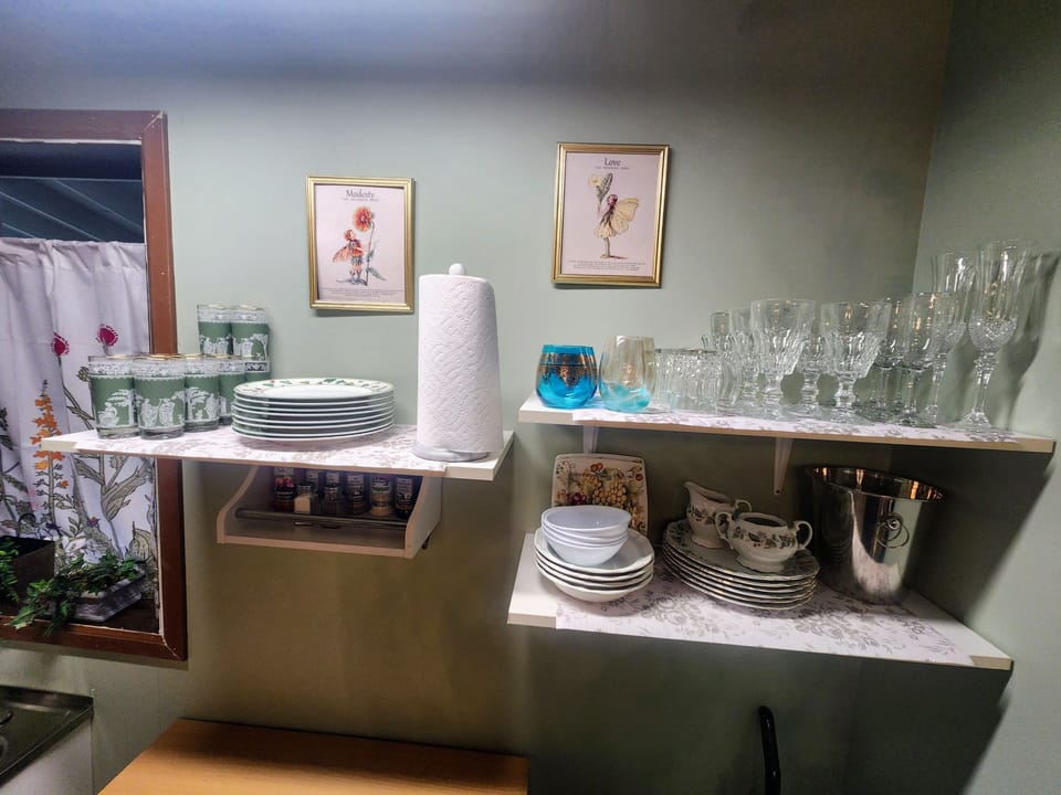 kitchen is well stocked with dishes and utensils, cooking spices, and storage.