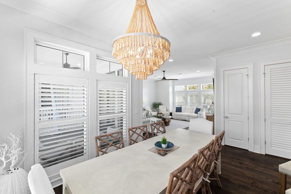 The dining area has a view of the living room.