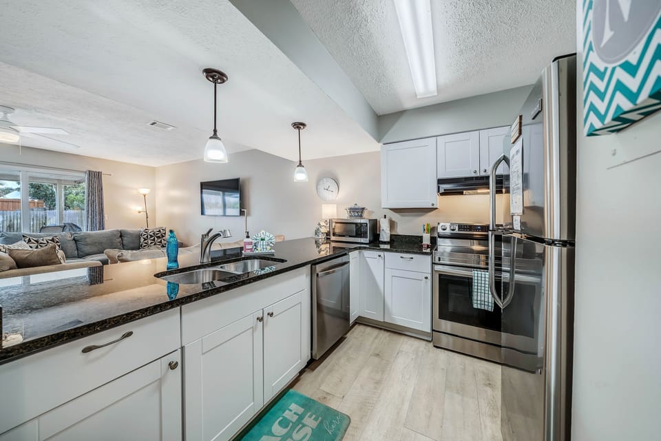 The fully equipped kitchen features granite countertops, stainless-steel appliances, and has everything you need to prepare meals for family and friends.