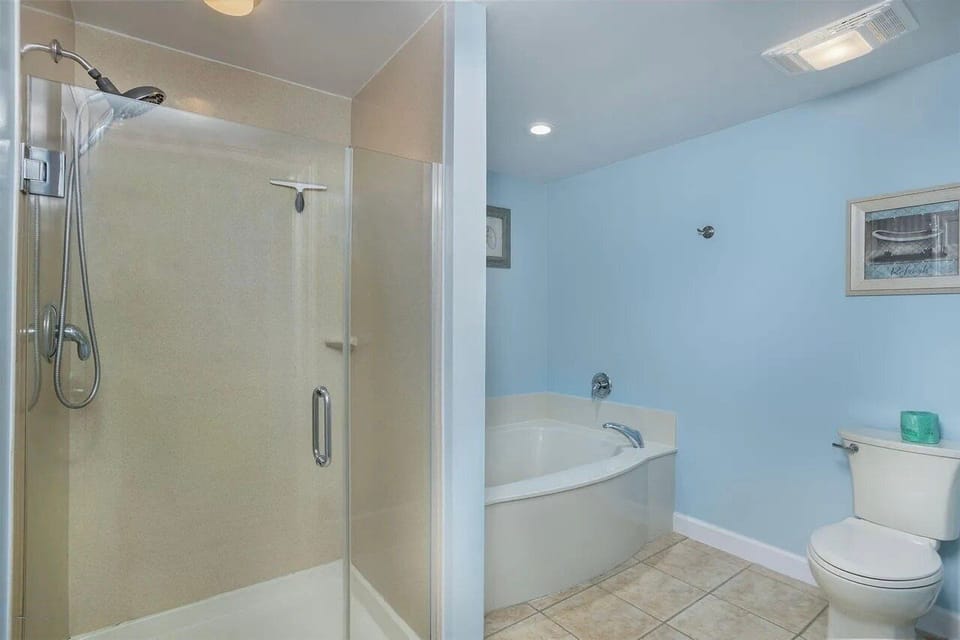 Master bathroom with dual vanity sinks and walk in shower + soaking tub