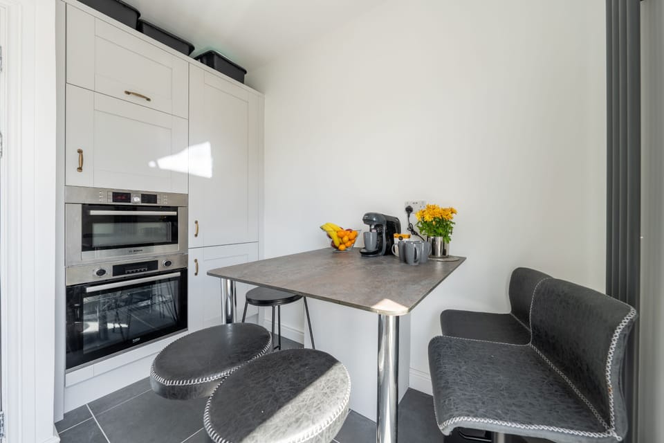 Kitchen with oven, microwave, dishwasher, coffee machine, fridge and freezer.