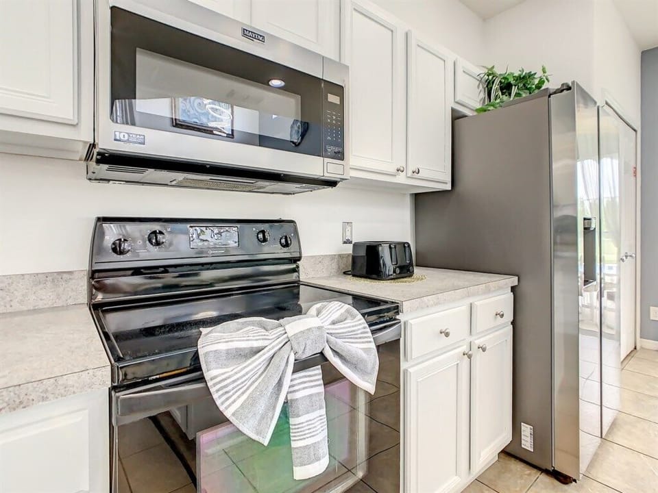Modern kitchen appliances and thoughtful touches for a cozy cooking experience.
