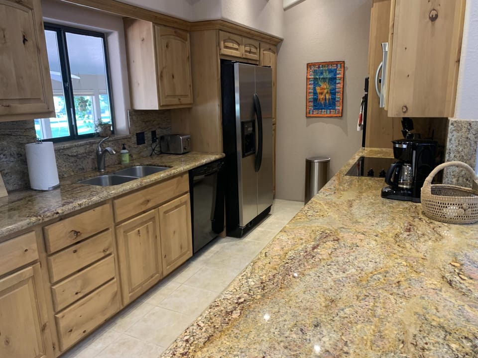 Fully equipped kitchen with views of the fairway.