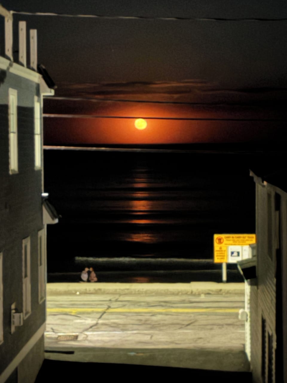 Beautiful full moon rising over the ocean.
