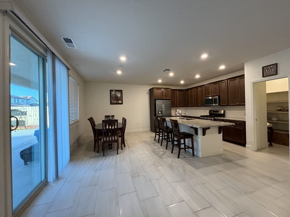 Kitchen with dining table for six people and a huge walk-in pantry.