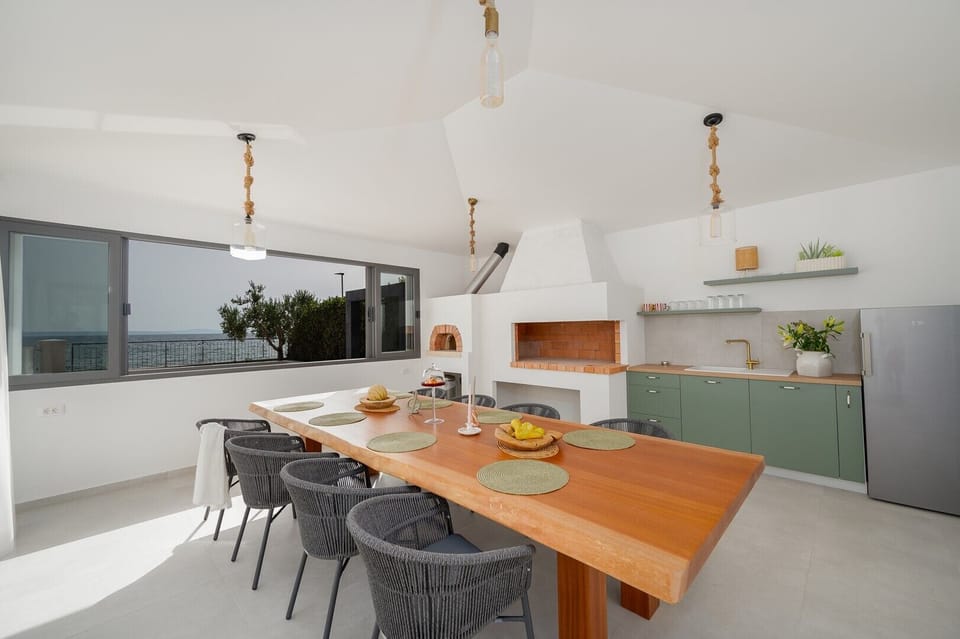 The covered outdoor area is a true oasis, complete with pool overlooking the azure sea
