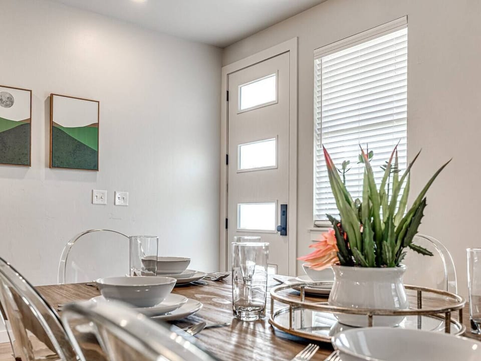 “Modern elegance: Dine in style amidst abstract art and natural light.”