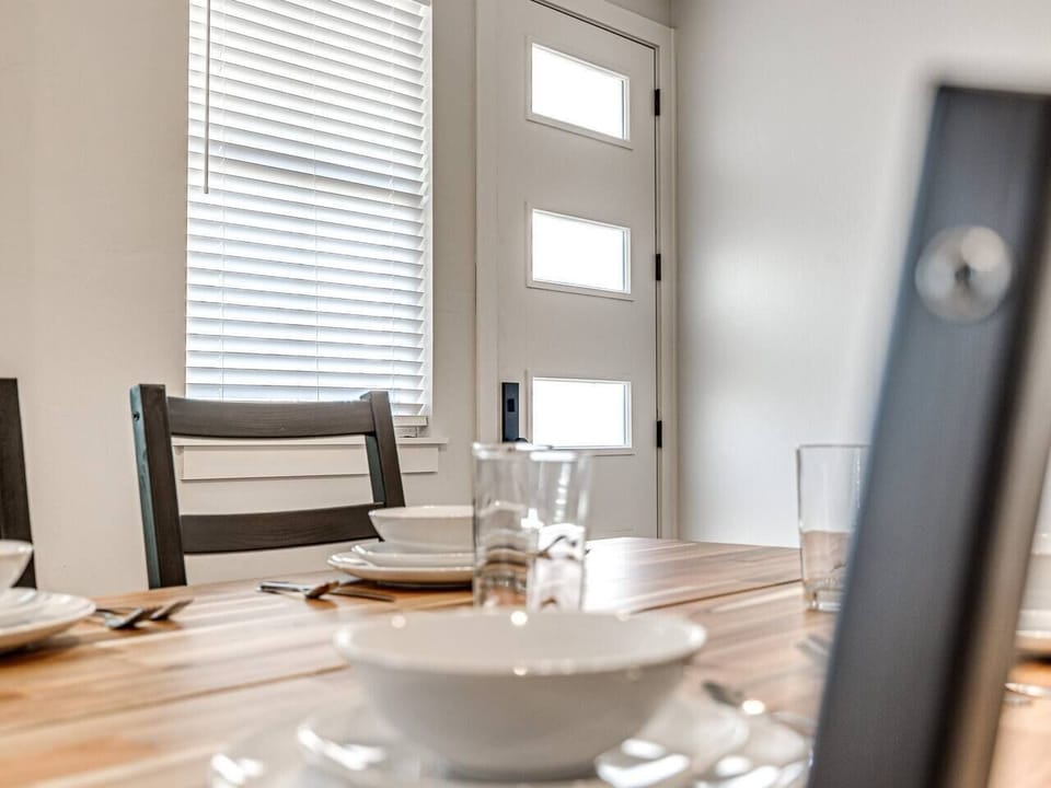 The essence of modern living is captured in the spacious open floor design, where the boundaries between the kitchen, dining, and living areas blur into a seamless expanse of welcoming space.