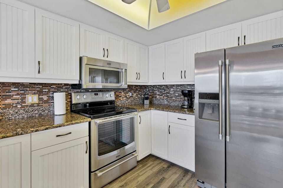 Coffee maker, toaster, dishes and utensils ready to use.  