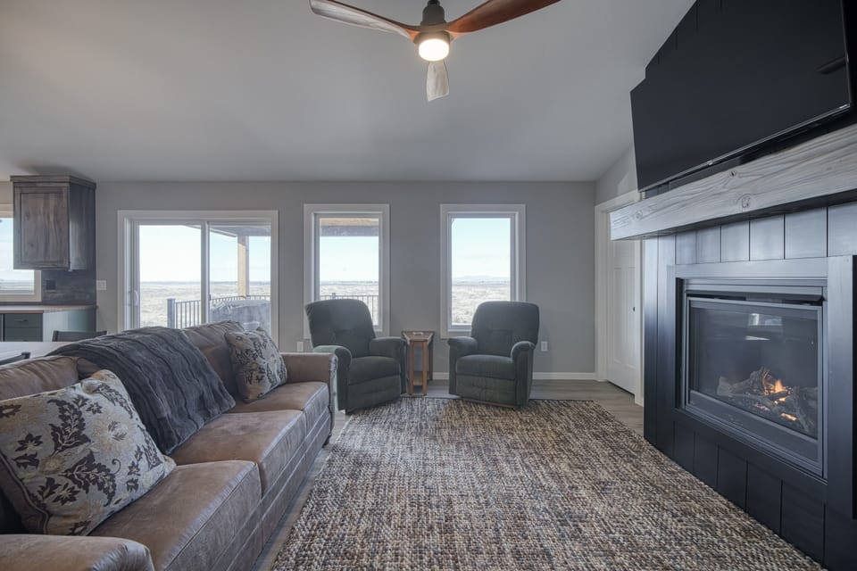 living room with fold out sofa bed, fireplace, and hdtv