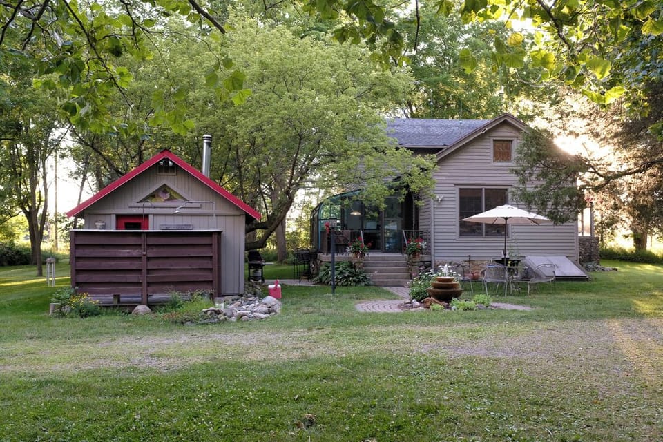 View of sauna and farmhouse.