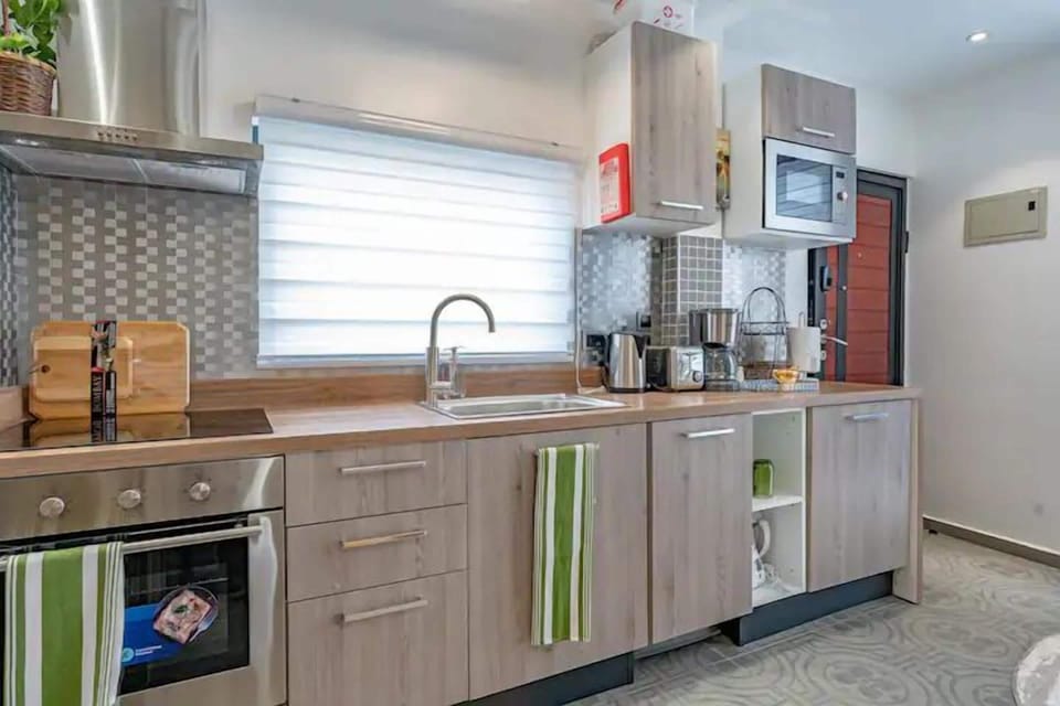 Fully equipped modern kitchen with coffee station, washer/dryer, refrigerator