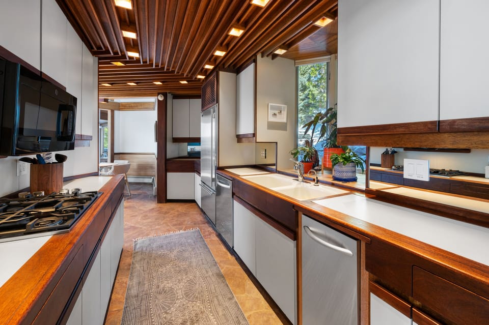 Galley kitchen has double ovens, gas cooktop & sub zero fridge & freezer.