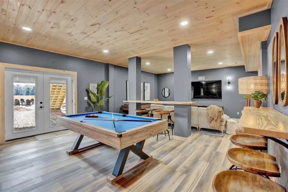 Spacious Game Room with Pool Table and Lounge Seating