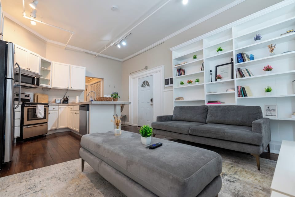 Enjoy the best of both worlds — relax in the cozy living area or cook in the modern, open kitchen surrounded by bright light and custom built-in shelving.