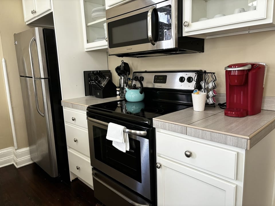 Fully equipped kitchen with stainless steel appliances, coffee maker, and all the essentials for a convenient stay.