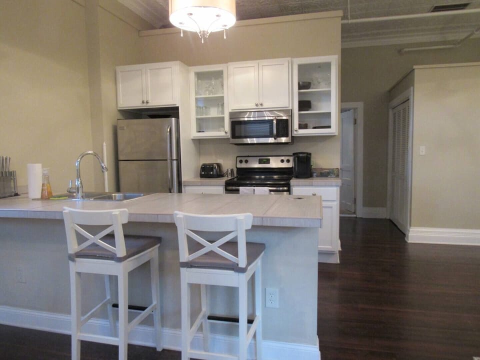 Modern kitchen with stainless steel appliances, a spacious island, and bar seating—perfect for cooking and casual dining.