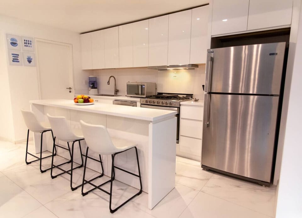 Cook and dine in style with a sleek kitchen featuring modern appliances and a breakfast bar.