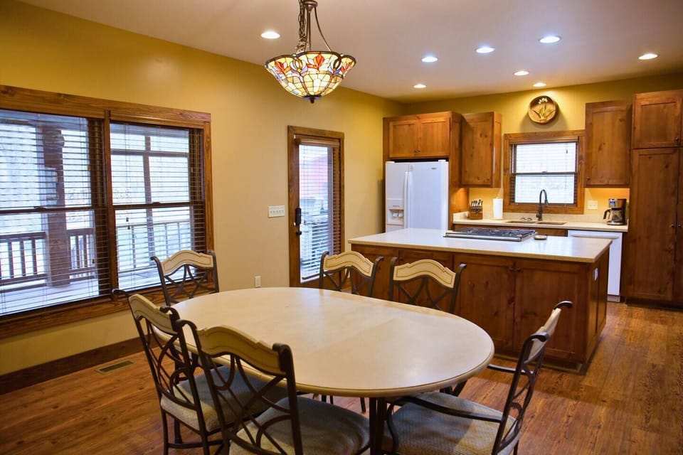 The dining table, located right next to the kitchen, comfortably seats 6.