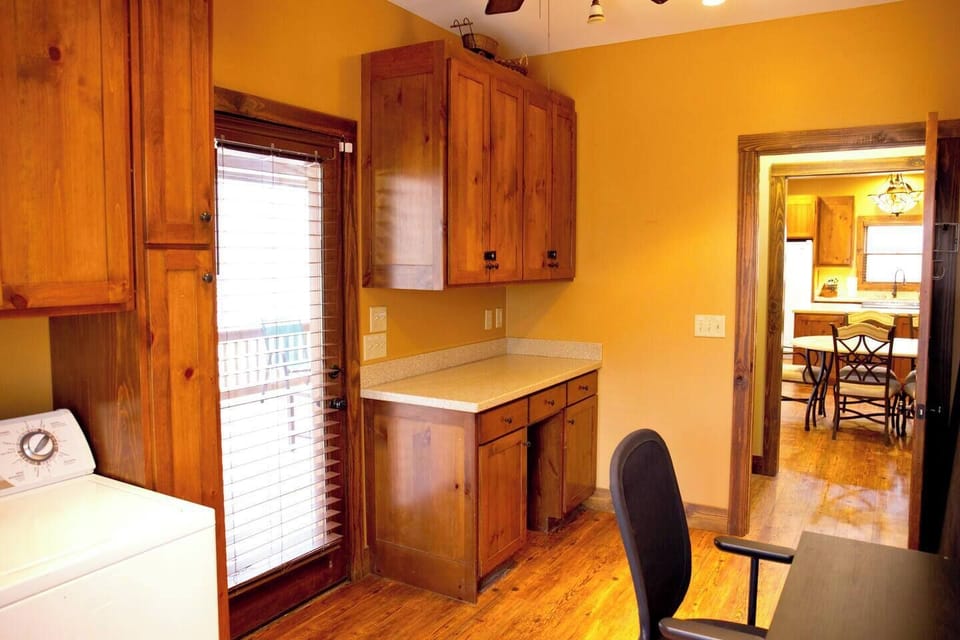The laundry area doubles as a work space, with a door that leads directly to the screened-in porch—perfect for stepping out and enjoying the fresh air during breaks.
