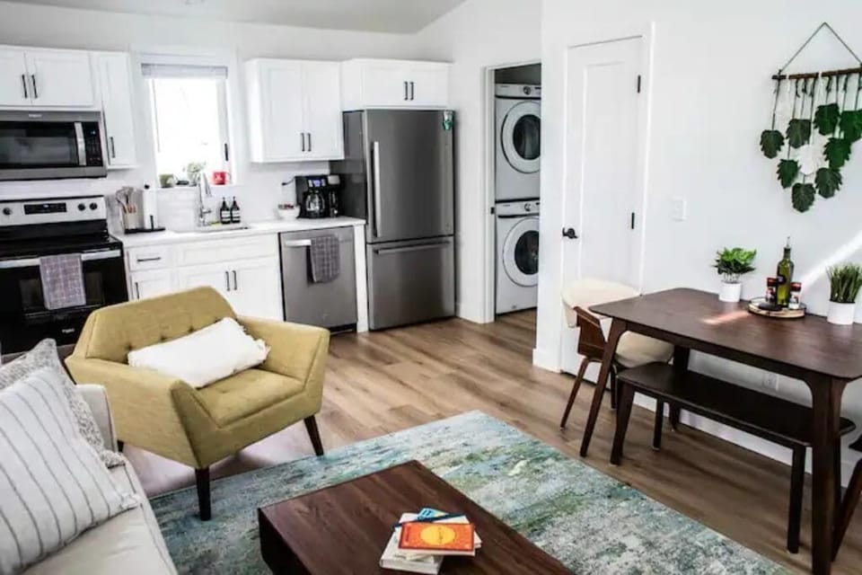 Here is our fully equipped kitchen and entry to the bathroom that includes a stackable washer/dryer for you to do laundry as needed!
